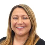 Karen-George White lady with light brown hair and grey eyes, wearing a black top.